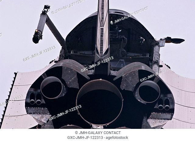 This view of the aft portion of the space shuttle Atlantis, including main engines, part of the cargo bay, vertical stabilizer and orbital maneuvering system...