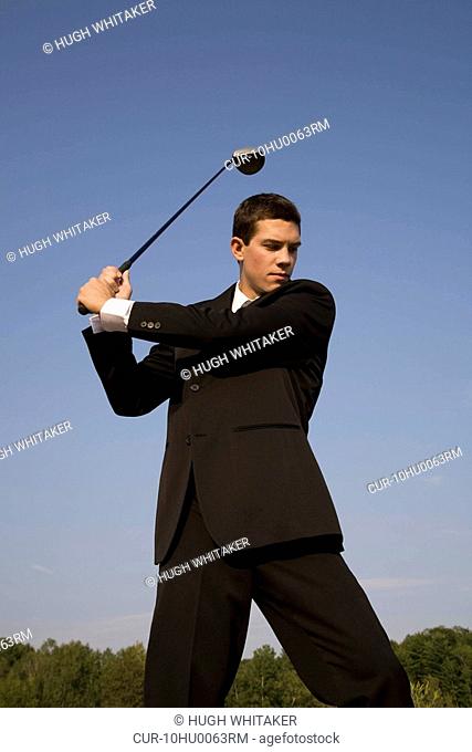 Business man playing golf