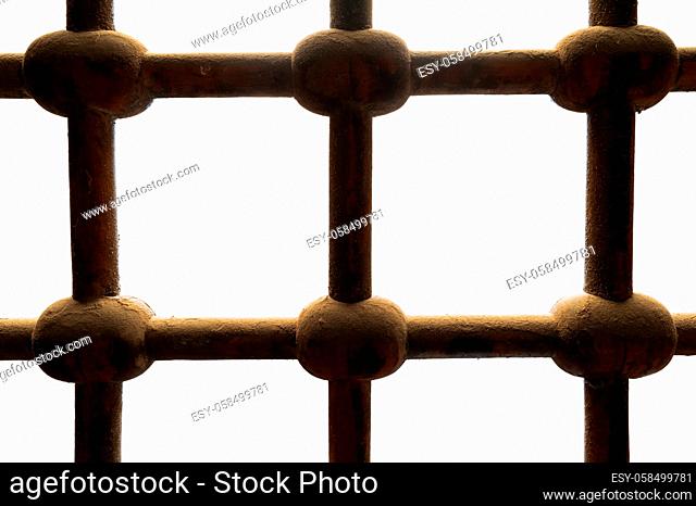 Old rusted grunge ornate intersected iron bars window isolated on white, includes clipping path
