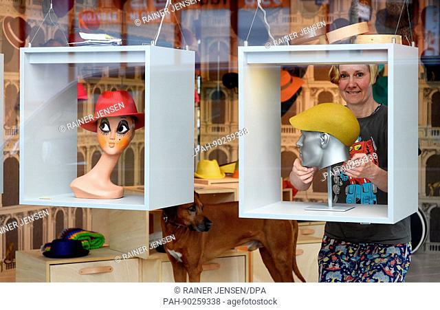 Hat designer Rike Feurstein at the shop window of her shop in Berlin, Germany, 11 April 2017. The hat designer keeps red-haired sheep in Grosswuestenfelde near...