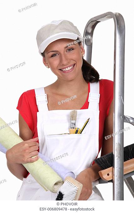 Woman with rolls of wallpaper and a stepladder