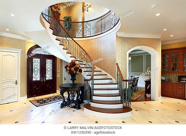 Foyer in luxury home with circular staircase