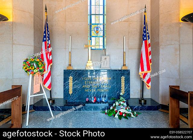 Hamm near Luxembourg city, Luxembourg - August 22, 2018: Interior chapel at American WW2 Cemetery with memorial plaque, garland flowers and American flag stars...