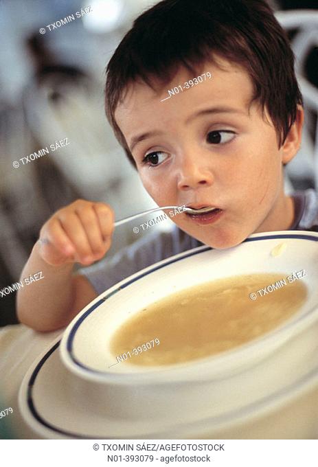 Boy eating soup