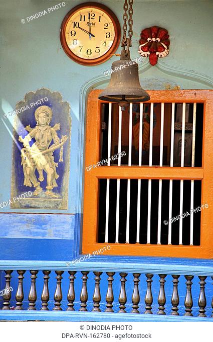 Wooden railing with window wall painting with brass bell and watch in Venkataraman temple ; Karkala ; district Udupi ; Karnataka ; India 5-May-2009