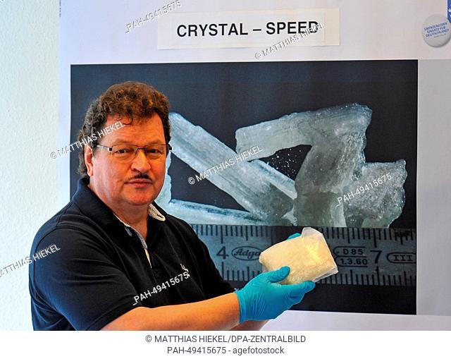 Customs officer Eberhard Thiedmann holds a seized bag of the drug Crystal meth during a press conference in Dresden, Germany, 16 June 2014