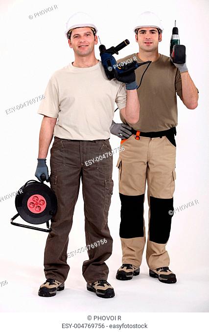 Two men holding power drills