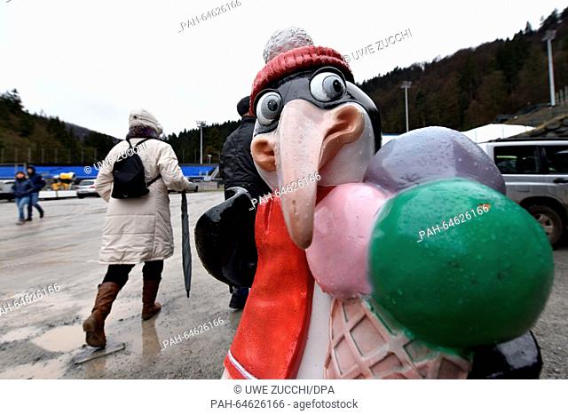 A penguin figure in winter clothes carrying an ice cone pictured in front of a coffee store at the Muehlenkopf ski jumping hill in Willingen, Germany