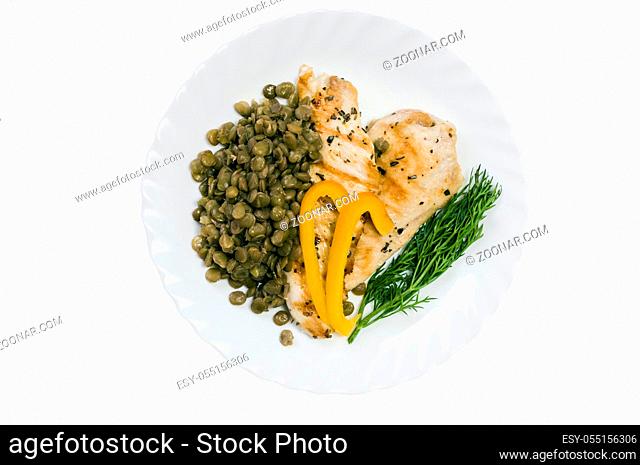 grilled chicken fillet with lentils on a white plate and isolated on white background