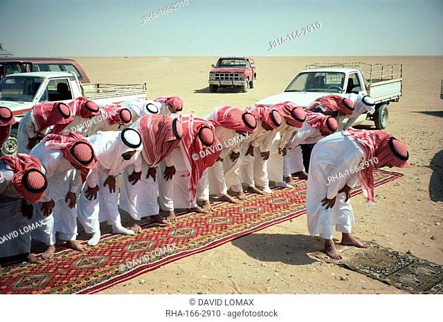 Group of Bedouin men at prayer, Saudi Arabia, Middle East