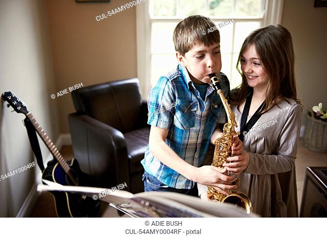 Children playing with saxophone