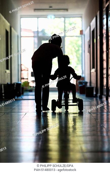 (IllUSTRATION) Two children play in a former barracks building, which now houses refugees in Lueneburg, Germany, 27 August 2014