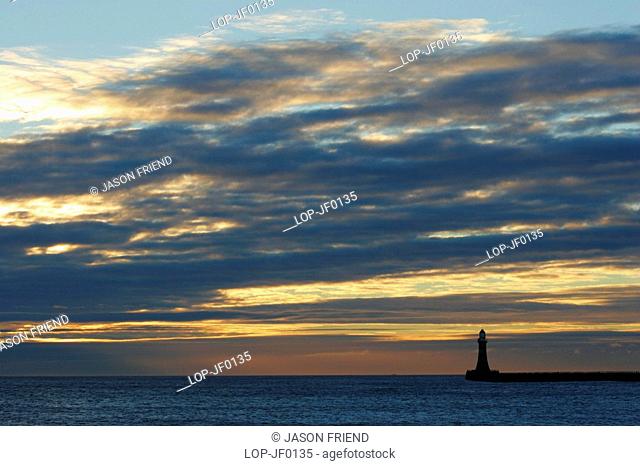 England, Tyne and Wear, Seaburn, Dawn looking across the North Sea towards the Roker pier and lighthouse