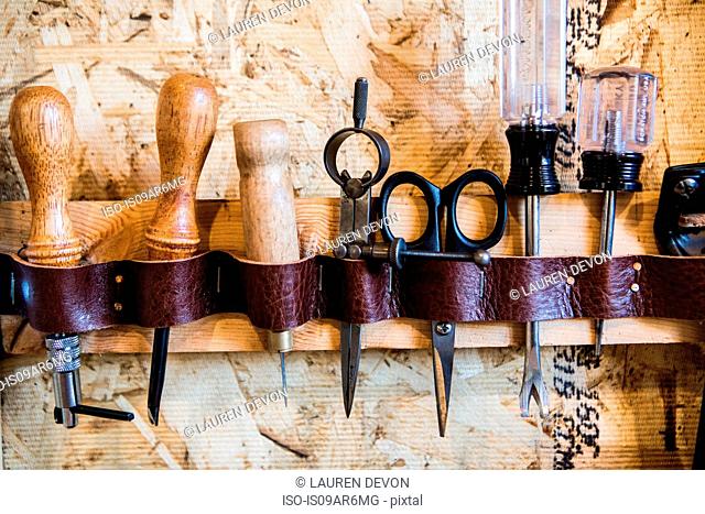 Row of hand tools on workshop wall