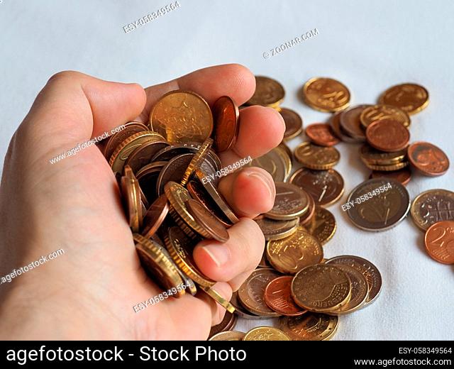 Hand handing Euro coins money (EUR), currency of European Union