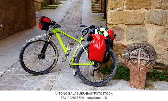 The way of Saint James stone sign in Cirauqui with bike Pamplona Spain