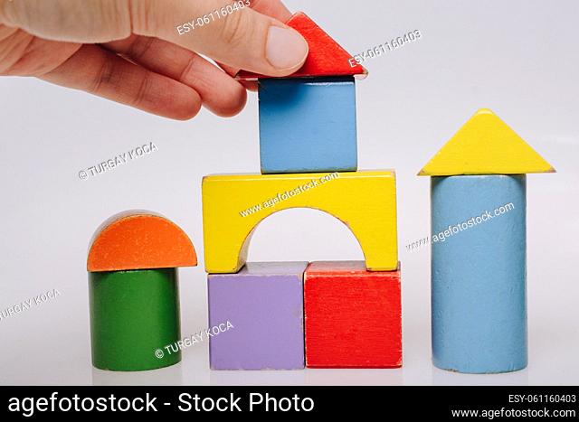 Hand building tower, castle with Bright colorful wooden blocks toy