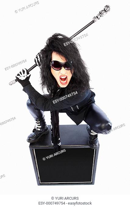 A crazy young rockstar with a guitar isolated over white background