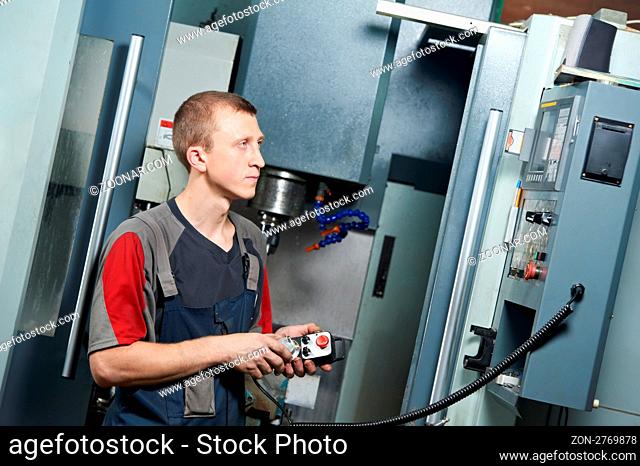 mechanical technician worker at metal machining milling center in tool workshop