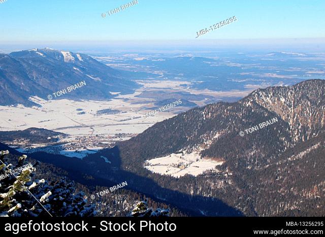 Winter hike through the mountain forest to the Simetsberg. Germany, Bavaria, Walchensee, Einsiedl, mountain view of Eschenlohe and the Murnauer Moos