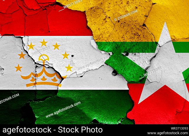 flags of Tajikistan and Myanmar painted on cracked wall