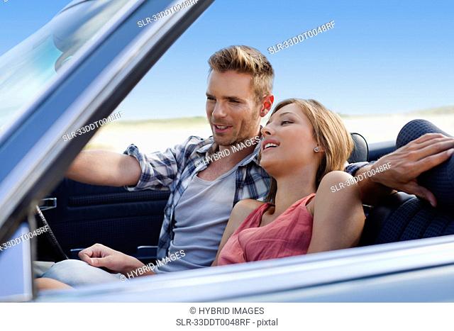 Couple riding in convertible