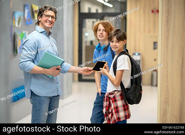 At school. School children and a teacher in a school corridor