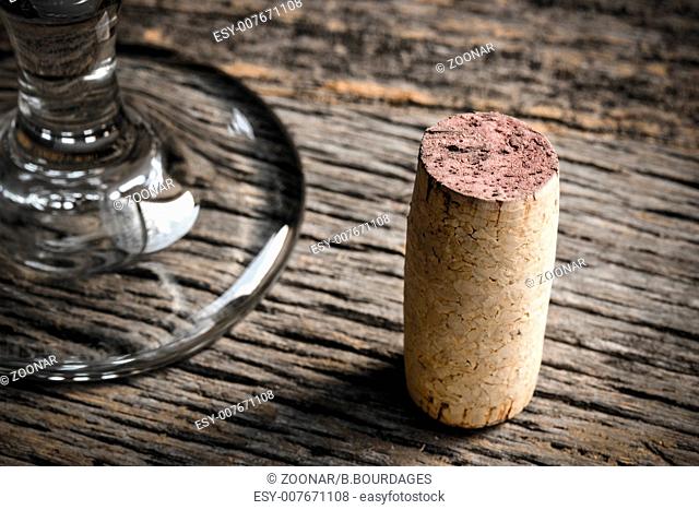 Wine Glass and Cork on Rustic Wooden Background