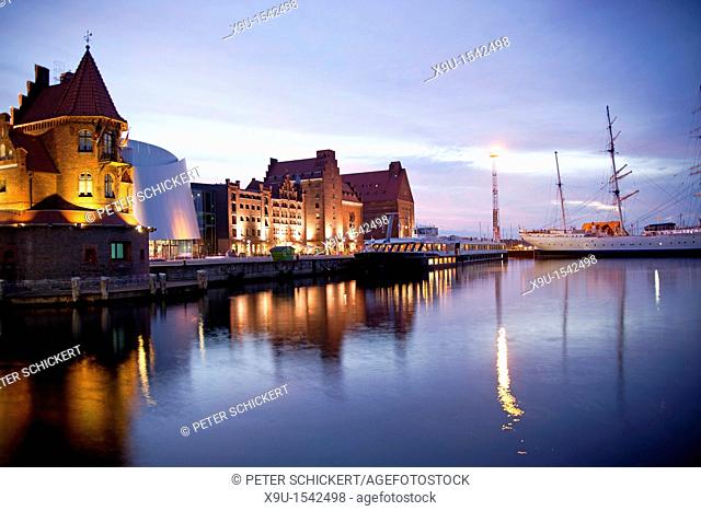 blue hour at the harbor with the building of the Maritime pilots, Ozeaneum and the three-mast barque Gorch Fock 1 in the Hanseatic City of Stralsund
