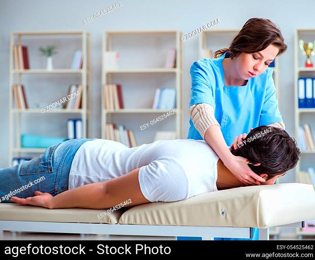 The female chiropractor doctor massaging male patient