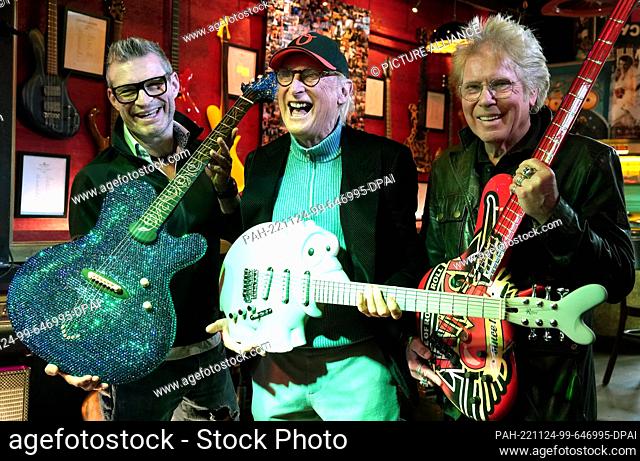24 November 2022, Hamburg: Guitar maker Jens Ritter (l-r), comedian and musician Otto Waalkes and Uli Salm, celebrity host and rock musician