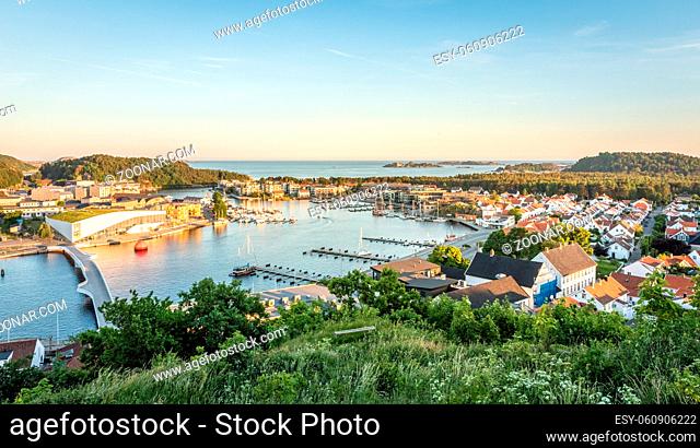 Mandal, a small city in the south of Norway. Seen from Uranienborg, green vegetation in front of the town, with the sea and the sky in the background