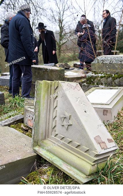 After a commemoration at a Jewish cemetery people are allowed to return to the graves in Sarre-Union, France, 17 February 2015
