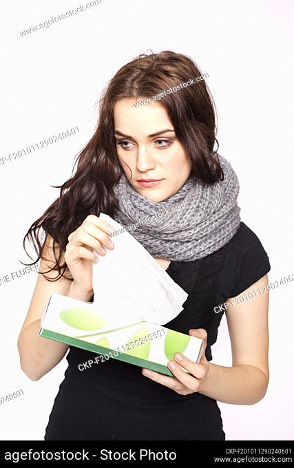 A beautiful young woman, lady, girl, cold, runny nose, headache, tissues, paper hankies, scarf  (CTK Photo/Rene Fluger) MODEL RELEASED, MR
