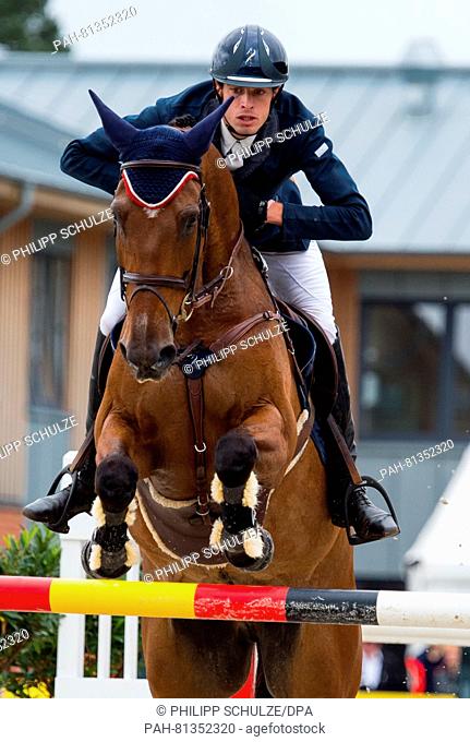 The French Maxime Livio jumps with on his horse Qalao des Mers over a hurdle at the four star tests of Eventing riders in Luhmuehlen, Germany, 19 June 2016