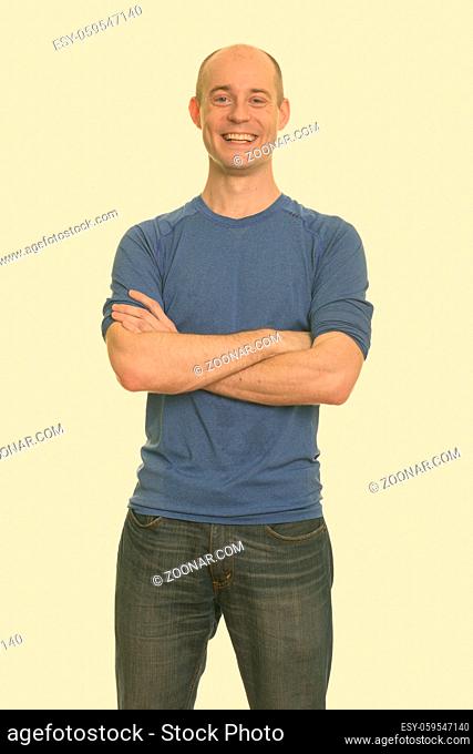Studio shot of handsome bald man isolated against white background