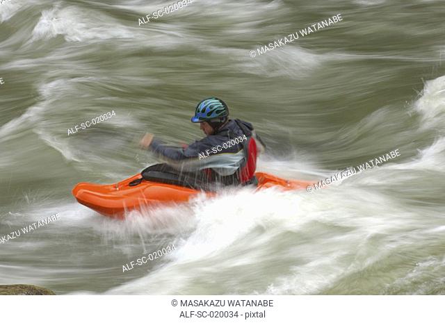 Kayaker Negotiating the River