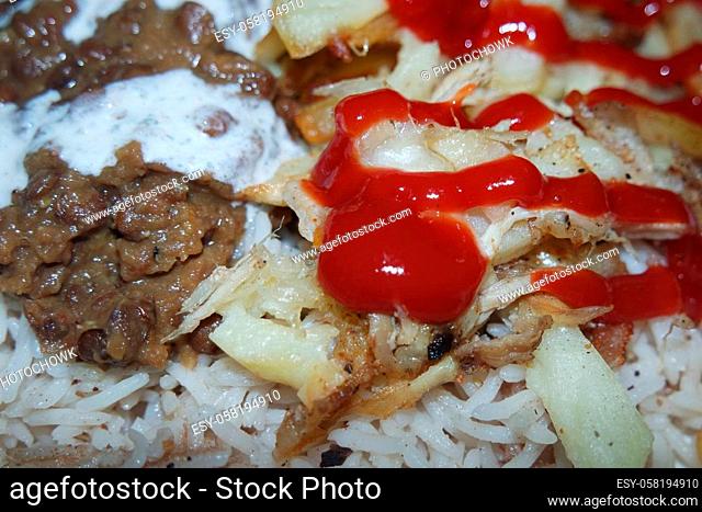 Delicious traditional dish of rice with potato fries and cereals with red ketchup. Food background with copy space for text and advertisements