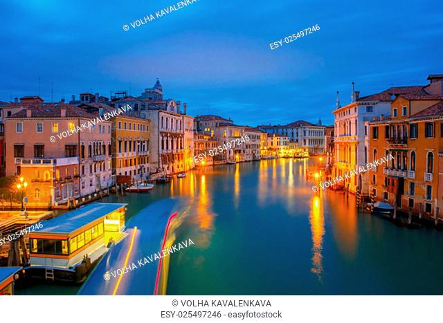 Night view of the Grand Canal and the Vaporetto stop from Accademia Bridge in Venice, Italy