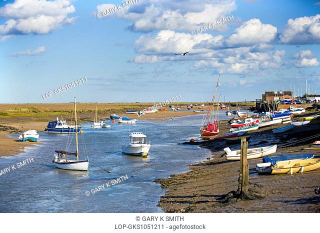 A view of Wells tidal harbour at low tide with pleasure craft looking eastwards