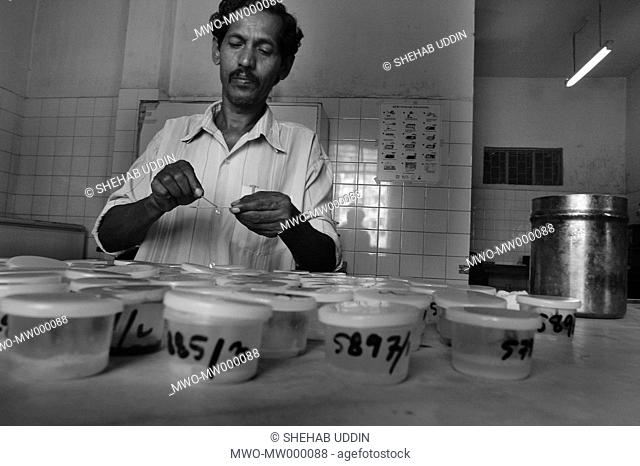 A health worker examines sputum in a DOT Center at Shamoli, Dhaka, Bangladesh July 25, 2005 Bangladesh ranks fifth among the world’s 22 highest burden TB...