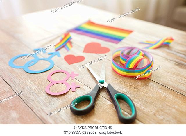 scissors and gay party props on wooden table