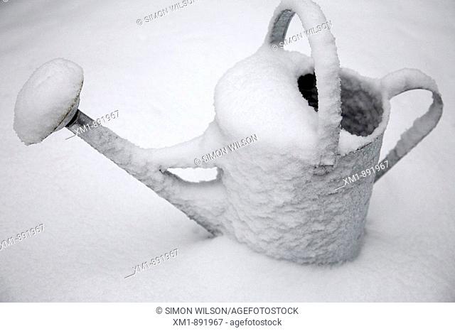 Snow covered watering can