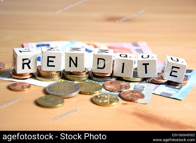 Rendite ( german for yield ) word written on wood cube