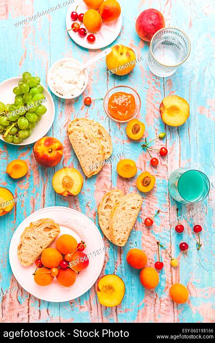 Ciabatta with peach and apricot jam, ricotta cheese, fruits and smoothie. Summer snack