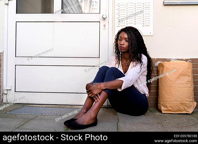 African Woman Waiting In Front Of Closed Door