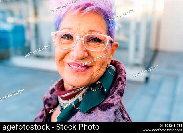 Italy, Portrait of fashionable senior woman with purple hair
