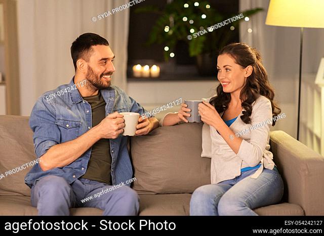 happy couple drinking tea or coffee at home