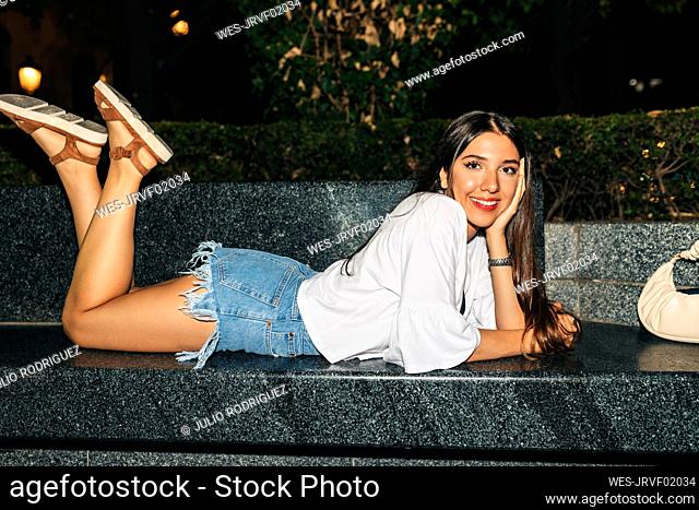 Beautiful woman lying on bench