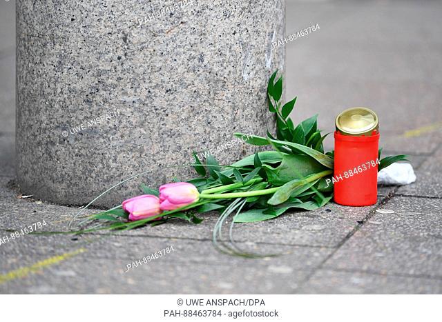 Flowers and a candle can be seen at the stone pillar where the car stopped after a deadly car-ramming on Saturday in Heidelberg, Germany, 26 February 2017